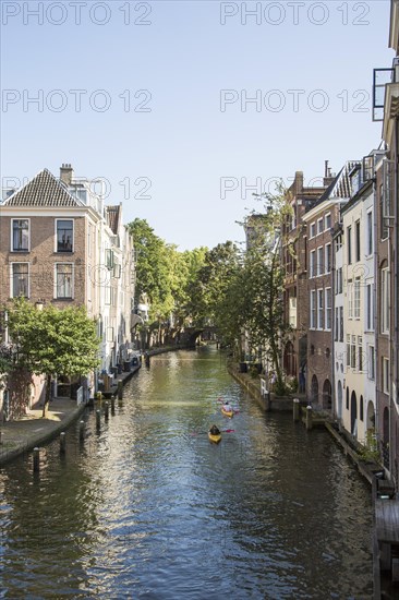 People kayaking on Oudegracht canal in central Utrecht, Netherlands