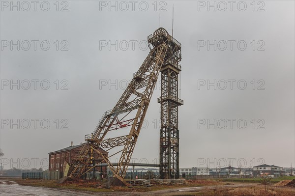 An old metal winding tower under a cloudy sky, a sign of the industrial past, Lost Place, Niederberg Colliery, Neukirchen-Vluyn, North Rhine-Westphalia, Germany, Europe