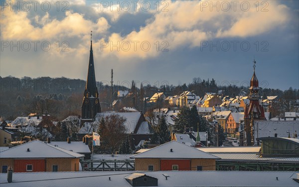 Golden sunlight over a snow-covered town with protruding church towers, Wuppertal Vohwinkel, North Rhine-Westphalia, Germany, Europe