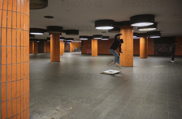 Germany, Berlin, 15.11.2023, Messedamm subway, orange columns, skaters, Europe
