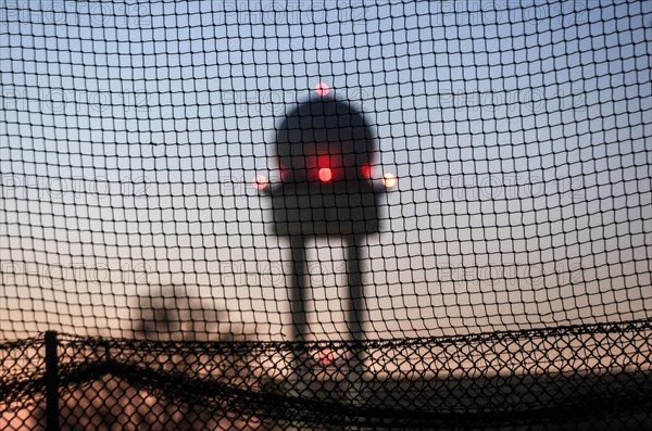 Evening mood at Tempelhofer Feld, view through a fence to the radar tower at the former Tempelhof Airport, Berlin, 15 December 2022