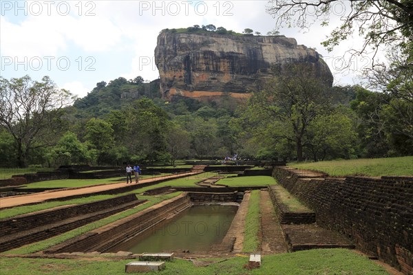 Tourists walking in the palace water gardens, Sigiriya Rock palace, Central Province, Sri Lanka, Asia