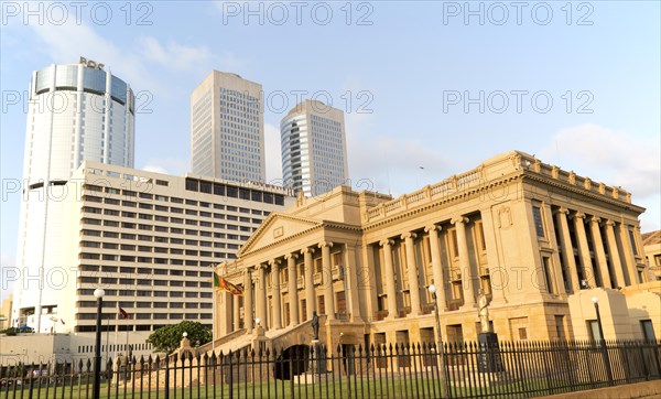 Old Parliament Building now the Presidential Secretariat offices, Colombo, Sri Lanka and modern skyscraper buildings