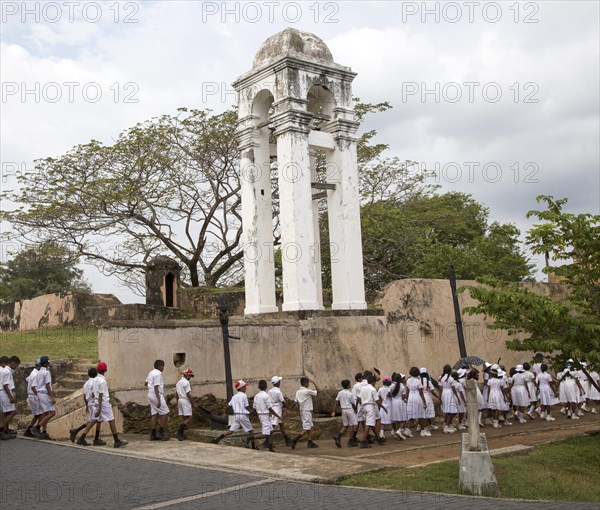 School children in uniform walking in a street in the historic town of Galle, Sri Lanka, Asia