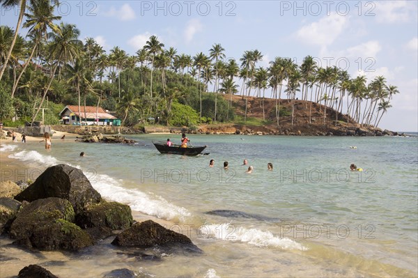 Tropical beach with people swimming Mirissa, Sri Lanka, Asia