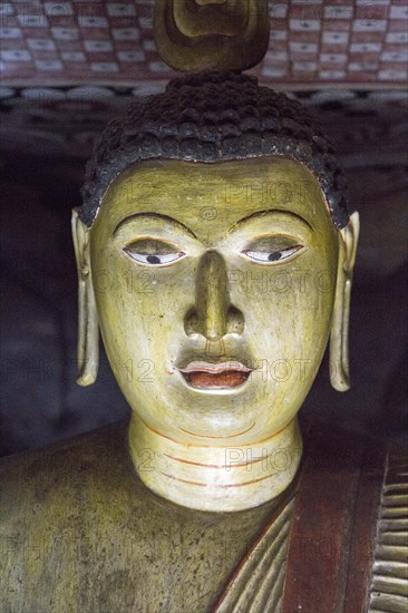 Buddha figure inside Dambulla cave Buddhist temple complex, Sri Lanka, Asia