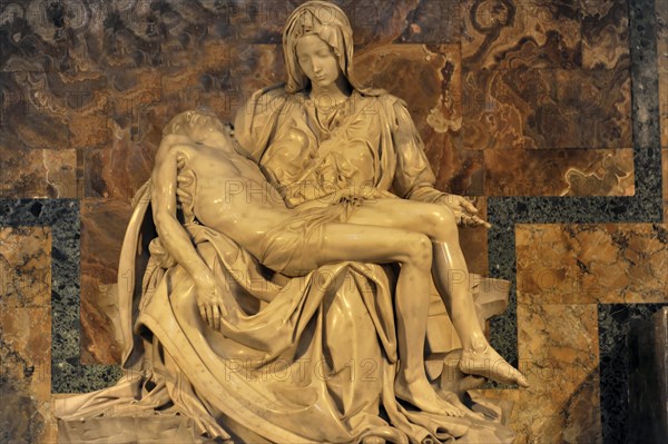 Marble sculpture Carrara white marble sculpture in warm light Pieta by Michelangelo Mary Mother of God mourns holding son, St Peter's Basilica, Vatican City, Vatican, Italy, Europe