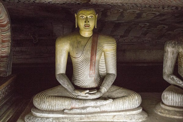 Buddha figure inside Dambulla cave Buddhist temple complex, Sri Lanka, Asia