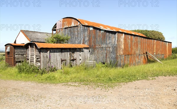 Rusty red barn the Gower peninsula, near Swansea, South Wales, UK