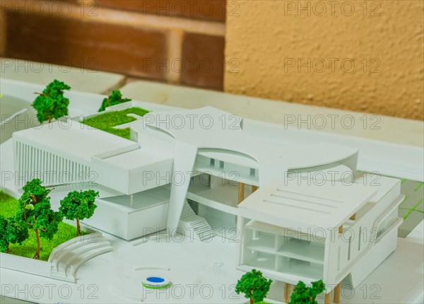 Closeup of student architectural design depicting large office building with green areas and open space