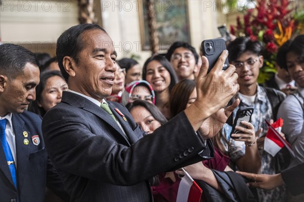 Joko Widodo, the President of Indonesia, takes selfies during a visit to Manila, Philippines 11/01/2024