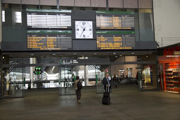 Electronic clock and display of travel information inside Santa Justa railway station, Seville, Spain, Europe