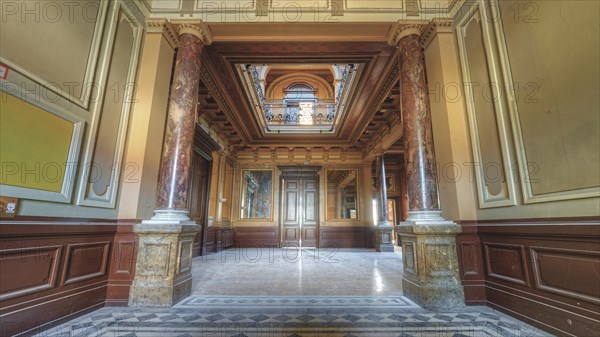 Symmetrical hallway with decorative ceiling and marble floor, flanked by columns, Villa Woodstock, Lost Place, Wuppertal, North Rhine-Westphalia, Germany, Europe