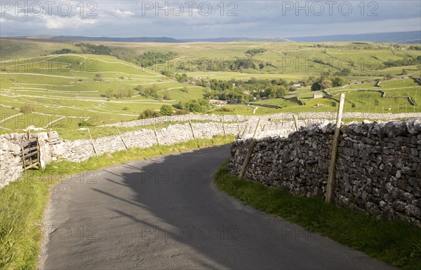 Country lane and dry stonewalls, Malham, Yorkshire Dales national park, England, UK