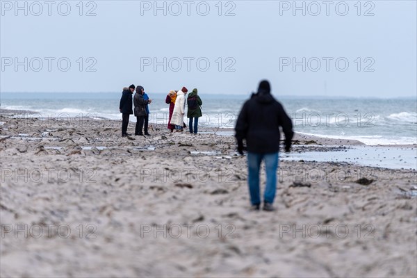 A group of people watching something on the beach in cold weather, Baltic Sea, Mecklenburg-Vorpommern, Germany, Europe