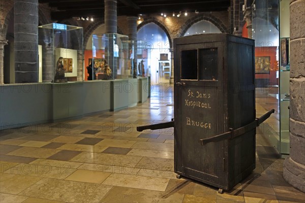 Medieval ambulance, sedan chair in the old sick-bay at the medieval Sint-Janshospitaal, St John's Hospital in the city Bruges, Flanders, Belgium, Europe