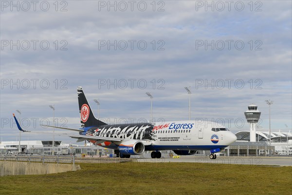 SunExpress with control tower taxiing from Terminal 1 onto Runway South, Munich Airport, Upper Bavaria, Bavaria, Germany, Europe