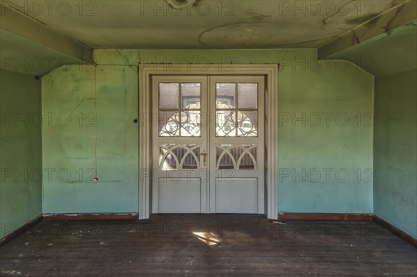 Abandoned room with peeling green wall paint and simple white doors, Schachtrupp Villa, Lost Place, Osterode am Harz, Lower Saxony, Germany, Europe