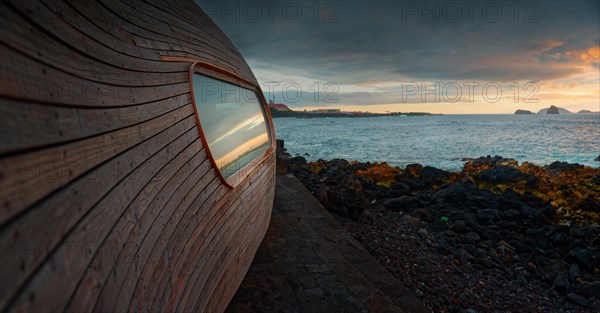 Modern wooden building of the famous Cella Bar on the coast with large window front at sunrise, Madalena, Pico, Azores, Portugal, Europe