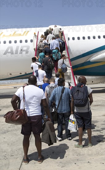 Passengers boarding Oman Airways plane, Seeb International Airport, Muscat, Oman, Asia