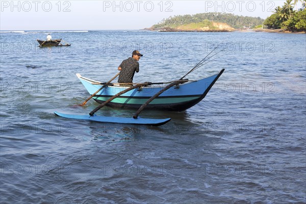 Fishing using traditional outrigger canoes, Mirissa, Sri Lanka, Asia