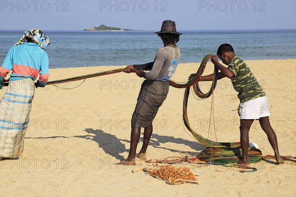 Traditional fishing hauling nets Nilavelli beach, near Trincomalee, Eastern province, Sri Lanka, Asia