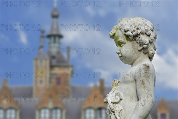 Angel statue in front of Ooidonk Castle, Kasteel van Ooidonk, 16th century Flemish Renaissance castle at Sint-Maria-Leerne, East Flanders, Belgium, Europe