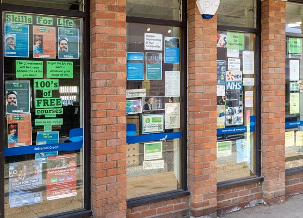 Posters and signs for training courses and job opportunities, window of Job Centre Plus, Woodbridge, Suffolk, England, UK