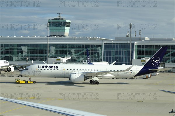 Lufthansa Airbus A 350-900 Braunschweig being towed across the apron of Terminal 2, Munich Franz Josef Strauss Airport, Munich, Bavaria, Germany, Europe