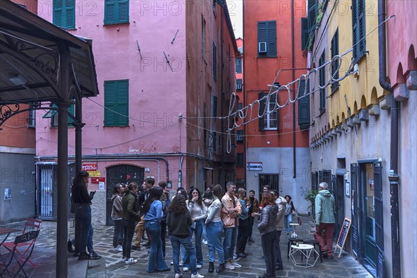 Meeting of students in the square of a historic wash house, Piazza Truogoli di Santa Brigida, Genoa, Italy, Europe