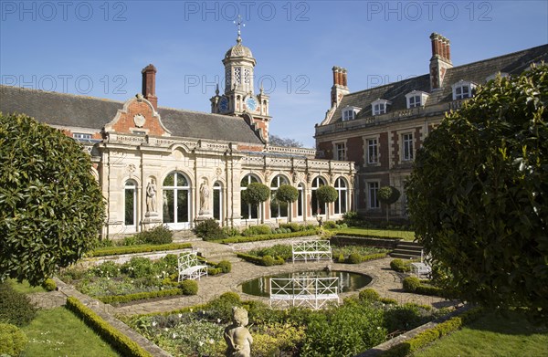 The White Garden and clock tower at Somerleyton Hall country house, near Lowestoft, Suffolk, England, UK