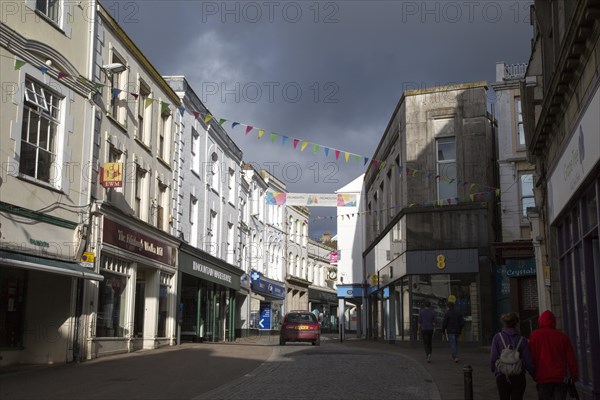 Threatening grey rain clouds over town centre street, Falmouth, Cornwall, England, United Kingdom, Europe