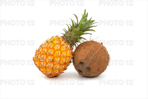 Whole pineapple fruit and coconut isolated on a white background