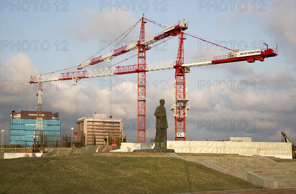 Cranes tower over statue of S.W.R.D. Bandaranaike at construction site in central Colombo, Sri Lanka, Asia