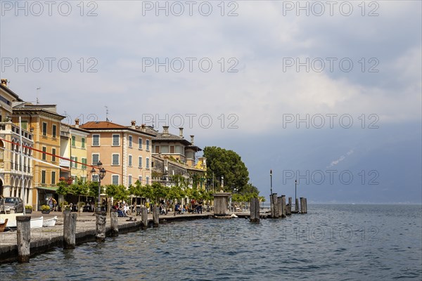 Waterfront promenade with restaurants in Gargnano, Lake Garda, Province of Brescia, Lombardy, Italy, Europe