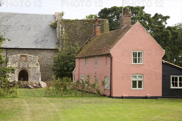 Historic pink cottage by church, Alderton, Suffolk, England, UK