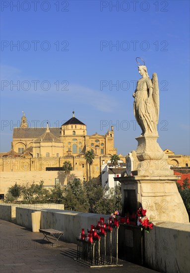 Angel San Rafael statue on Roman bridge with views cathedral, Cordoba, Spain, Europe