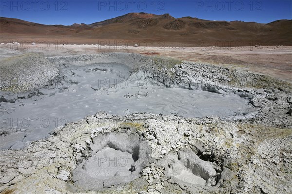 Mud lakes and steam pools with boiling mud in geothermal field Sol de Manana, Altiplano, Bolivia, South America