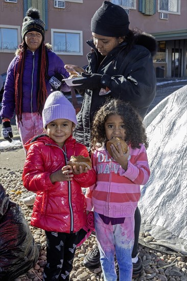 Denver, Colorado, Immigrants, mostly from Venezuela, live in a tent camp near downtown Denver. The city helped about 35, 000 migrants in 2023 with food and temporary shelter, but more continue to arrive daily on buses from the southern border