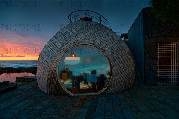 Spherical wooden building of the Cella Bar with modern design at sunset, reflections on the glass window, Madalena, Pico, Azores, Portugal, Europe