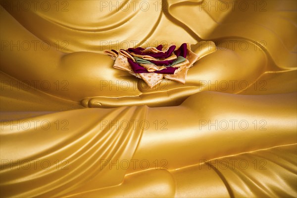 Detail of Buddha statue with offering in palm of hands, Gangaramaya Temple, Colombo, Sri Lanka, Asia