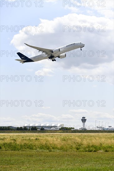 Lufthansa Airlines Airbus A350-900 taking off on Runway North with control tower, Munich Airport, Upper Bavaria, Bavaria, Germany, Europe