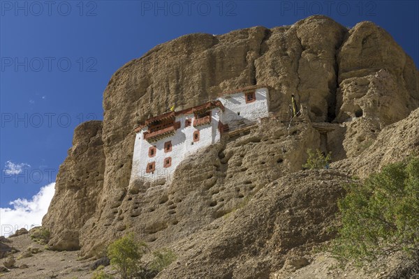 Impressively located Shergol Gompa, the Buddhist monastery partially set in the mountain cave closed by this awe-inspiring facade. The hill here is built of quite loosely-cemented conglomerate, which is prone to carving. Many inhabitants of Ladakh follow the Tibetan Buddhism, and this Indian region is often called Little Tibet. Shergol, the village located near the Srinagar-Leh road, Zanskar Range of the Himalayas, Kargil District, Union Territory of Ladakh, India, Asia
