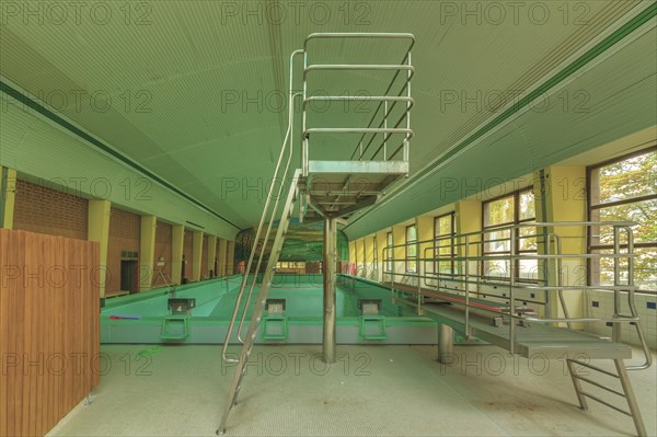 An abandoned swimming pool with a slide and a green-yellow colour scheme, Bad am Park, Lost Place, Essen, North Rhine-Westphalia, Germany, Europe