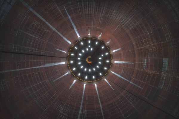 View into the inside of an industrial tower with a round light element in the centre, abandoned gasometer, Lost Place, Dortmund, North Rhine-Westphalia, Germany, Europe