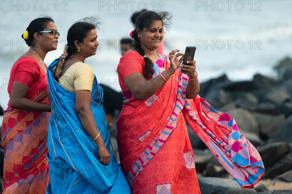 Indian women in saris on the beach, promenade, former French colony Pondicherry or Puducherry, Tamil Nadu, India, Asia