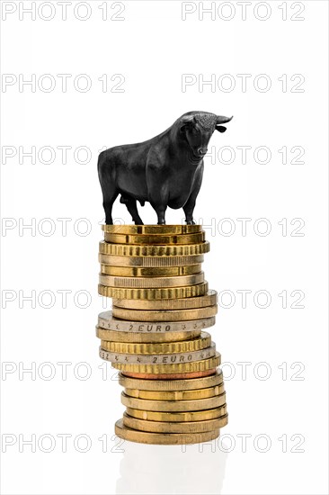 Bull stands on stacks of money, rising stock market prices, studio