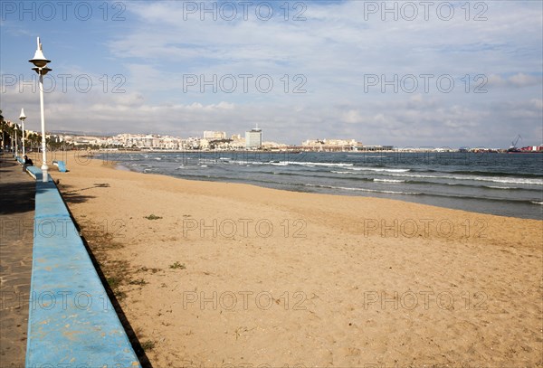 Sandy beach with view to historic walled fort of Melilla la Vieja, Melilla autonomous city state Spanish territory in north Africa, Spain, Europe