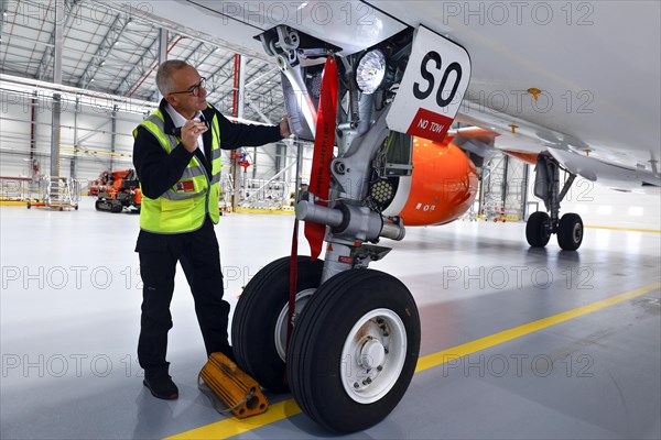 Olaf Gross, Licence Engineer at easyJet, checks the landing gear of an Airbus A320 Neo in front of the opening of the new easyJet maintenance hangar at Berlin Brandenburg Airport, BER. The entire European easyJet fleet is now maintained at the Schoenefeld site, 11.01.2023