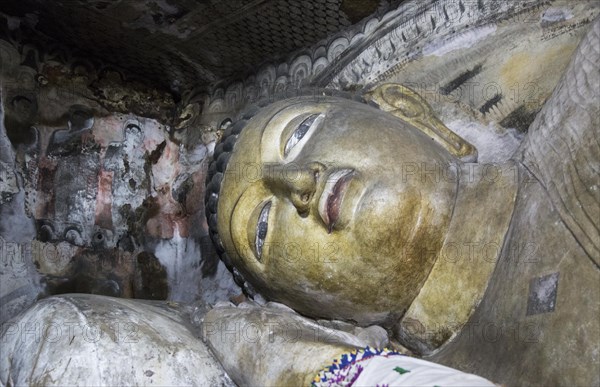 Buddha figure inside Dambulla cave Buddhist temple complex, Sri Lanka, Asia